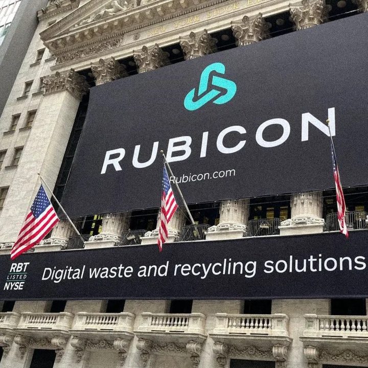 Rubicon banner hung on the New York Stock Exchange facade, flanked by American flags