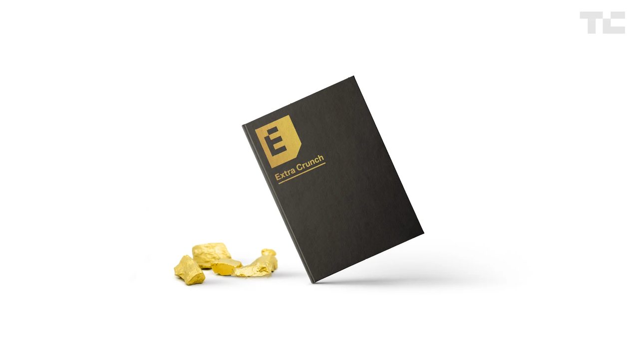 Black Extra Crunch notebook with gold logo beside gold nuggets