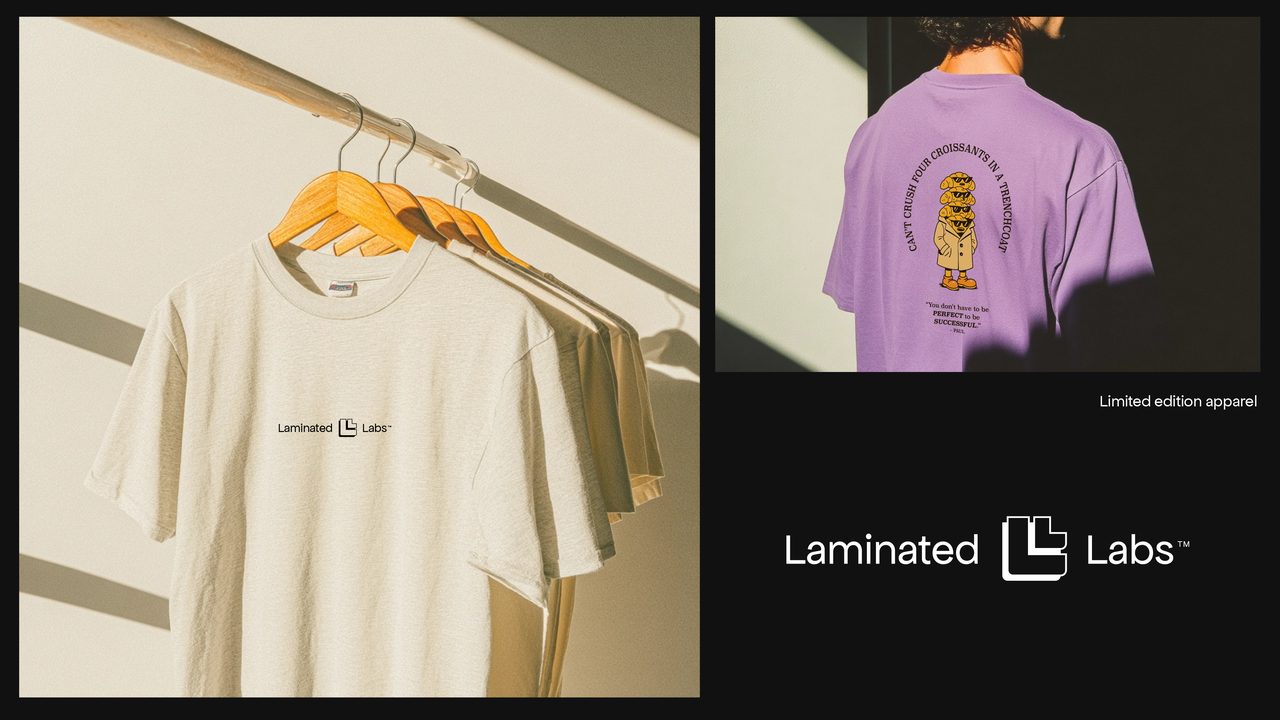 Laminated Labs t-shirts on hangers next to a purple shirt with a mascot print